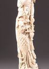 An ivory figure of a lady holding phoenix feathers