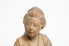 A soft paste light brown figure of a reclining farm girl