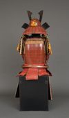 A RED LACQUER JAPANESE SUIT-OF-ARMOUR BY SATSUMA KUNIZUMI, 11TH GENERATION MITSUNOBU, MID 20TH CENTURY