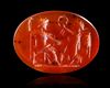 A CARNELIAN INTAGLIO SHOWING JUPITER SEATED WITH VICTORY, 2ND-3RD CENTURY AD
