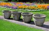 A SET OF FOUR COMPOSITION STONE GARDEN PLANTERS, SECOND HALF 20TH CENTURY