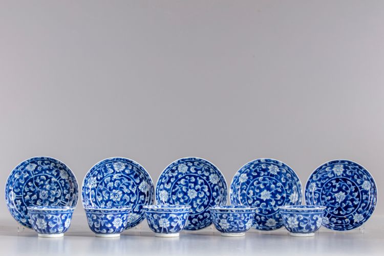 Five blue and white cups and seven saucers
