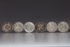 Five Chinese silver coins and a silver Mexican peso