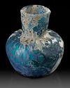 A MOULDED BLUE GLASS BOTTLE, NISHAPUR, NORTH-EAST PERSIA, 9TH CENTURY