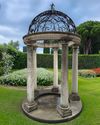 A CARVED LIMESTONE AND WROUGHT IRON MOUNTED ROTUNDA, 20TH CENTURY