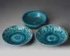 Two Islamic turquoise glazed dishes and a bowl.
