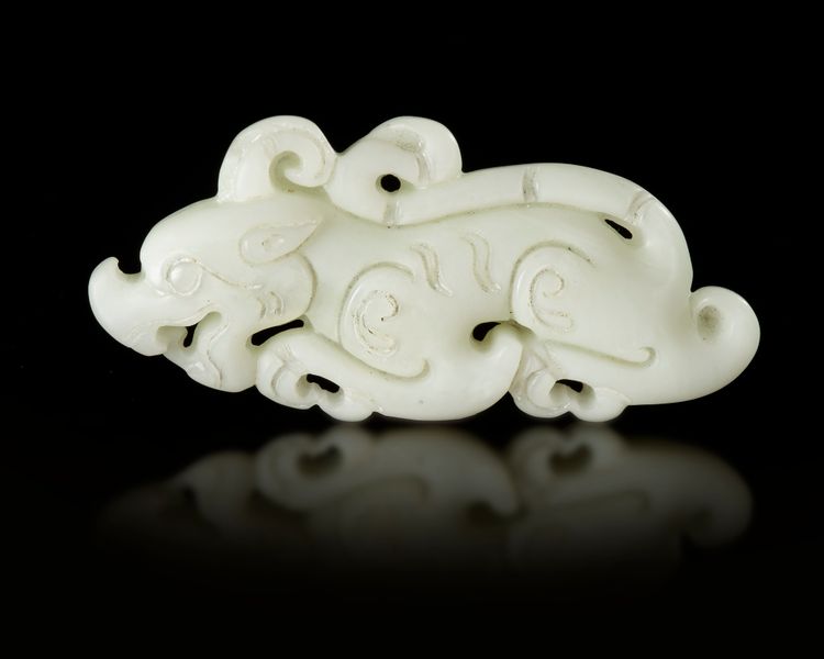 A CHINESE WHITE JADE BUDDHIST LION PENDANT, 20TH CENTURY