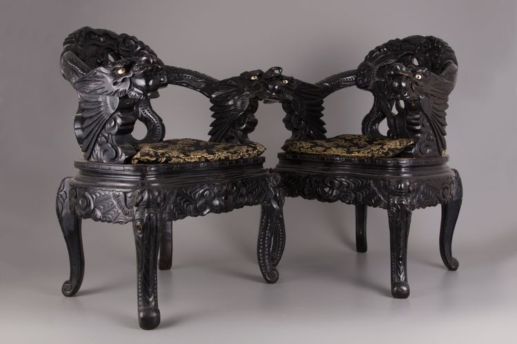 A pair of Chinese hardwood dragon chairs