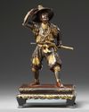 A Japanese parcel gilt bronze figure of a Samurai