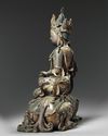 A bronze figure of guanyin seated on a mythical beast