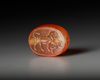 AN EASTERN GREEK CARNELIAN SCARABOID SEAL WITH LION, CIRCA 5TH CENTURY B.C.