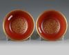 A pair of Chinese coral-ground famille rose 'Tilling and Weaving' bowls