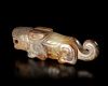 A JADE OF A RECUMBENT TIGER WITH ITS TAIL CURLED UPWARD, CHINA, SHANG DYNASTY
