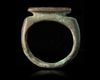 AN ISLAMIC KUFIC INSCRIBED BRONZE RING, 7TH-8TH CENTURY