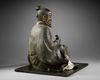 A JAPANESE SEATED LEGENDARY FIGURE WITH HAY BALE, 18TH CENTURY