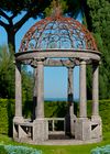 A CARVED LIMESTONE AND WROUGHT IRON MOUNTED ROTUNDA, LATE 20TH CENTURY