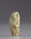 A Chinese pale celadon jade 'boy and lingzhi' carving