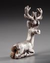 AN ELAMITE SILVER RECLINING STAG, CIRCA 2ND CENTURY B.C.