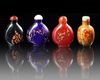 A GROUP OF FOUR CHINESE PEKING GLASS SNUFF BOTTLES