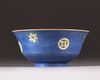 A Chinese blue-ground sgraffiato famille rose 'roundels' bowl