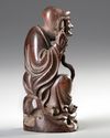 A CHINESE WOOD CARVING OF A LOHAN, 20TH CENTURY