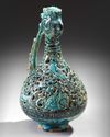 A RARE FRITWARE OPENWORK DECORATED RETICULATED EWER WITH ROOSTER HEAD, PERSIA, 13TH CENTURY