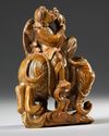 A CHINESE SOAPSTONE CARVED LUOHAN RIDING AN ELEPHANT, 19TH CENTURY