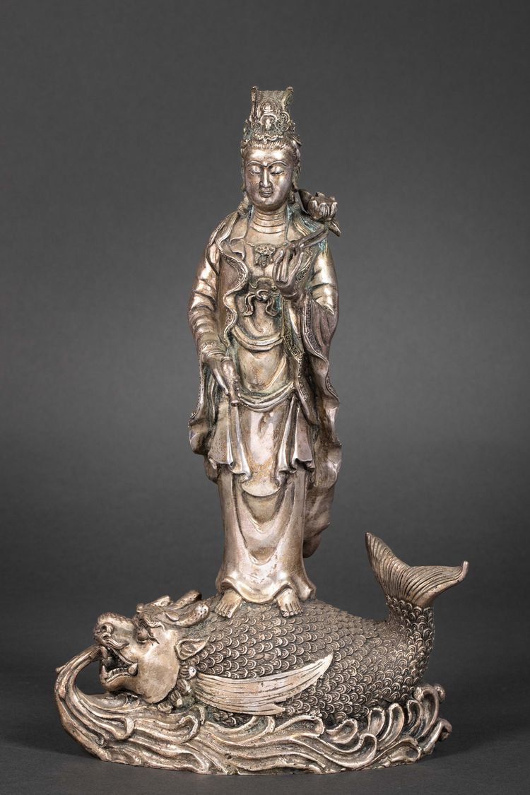 A METAL SCULPTURE OF GUANYIN STANDING ON A FISH, 20TH CENTURY