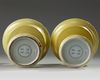 A pair of Chinese yellow-glazed candlestick holders
