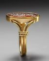 A RENAISSANCE CARNELIAN INTAGLIO PORTRAIT OF THE EMPEROR HADRIAN IN A MODERN GOLD RING, CIRCA 17TH CENTURY A.D.