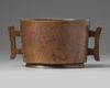 A CHINESE BRONZE TWIN-HANDLED CENSER