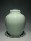 A PAIR OF CHINESE CELADON-GLAZED JARS AND COVERS