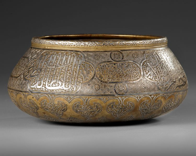A PERSIAN SILVER INLAID BRASS BASIN, ILKHANID 14TH CENTURY