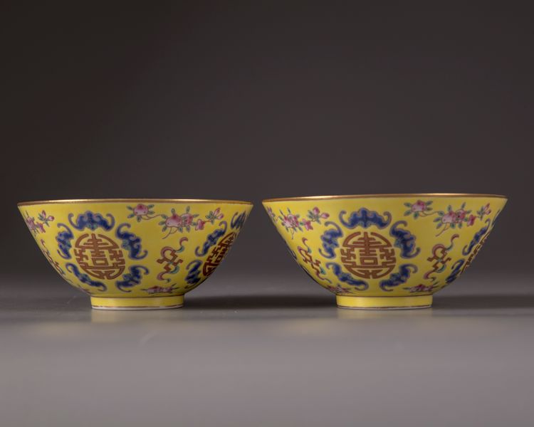 A pair of Chinese yellow-ground famille rose bowls