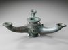 A BYZANTINE THREE -SPOUTED BRONZE OIL LAMP, CIRCA 4TH-5TH CENTURY A.D.