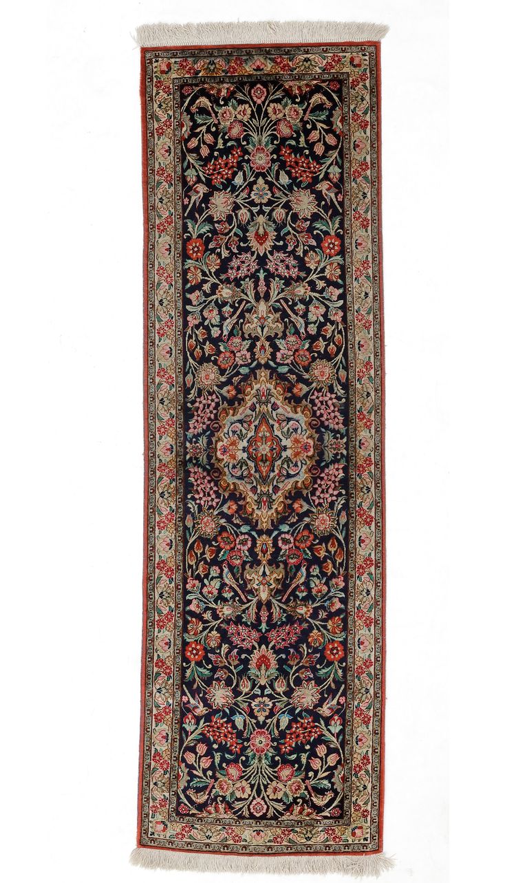 A SILK GHOM RUNNER CAPET.