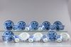 A group of eleven blue and white saucers and ten cups