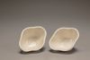A pair of white-glazed lobed cups