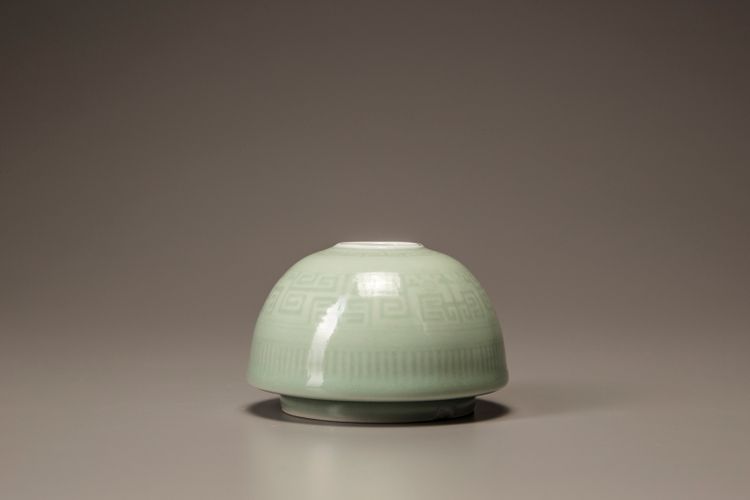 A small celadon-glazed water pot