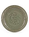 A CHINESE LONGQUAN CELADON MOULDED DRAGON DISH, MING DYNASTY (1368-1644)
