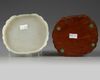 A Chinese pale celadon jade 'peach' plaque on a hongmu box
