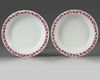 A pair of Chinese famille rose jardinieres and stands