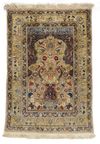 A FINE SILK AND METAL TURKISH HEREKE SILK RUG