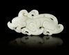 A CHINESE WHITE JADE BUDDHIST LION PENDANT, 20TH CENTURY