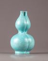 A Chinese celadon-ground white-enamel-decorated conjoined triple-neck double-gourd vase