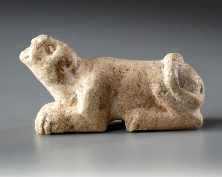 A WESTERN ASIATIC ELAMITE AMULET LIMESTONE WITH LION SEATED, CIRCA 2ND-1ST MILLENNIUM  B.C.