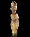 A GREENISH-YELLOW JADE CARVING OF A HORNED STANDING FIGURE, CHINA, HONGSHAN CULTURE