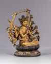 A MULTI-ARMED GILT CHINESE BRONZE FIGURE OF GUANYIN