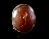 A BROWN AGATE INTAGLIO OF A FAUN, 2ND-1ST CENTURY BC
