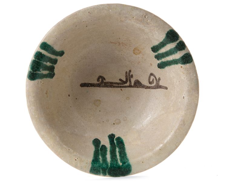 AN ABBASID TIN GLAZED POTTERY BOWL, MESOPOTAMIA, 9TH CENTURY